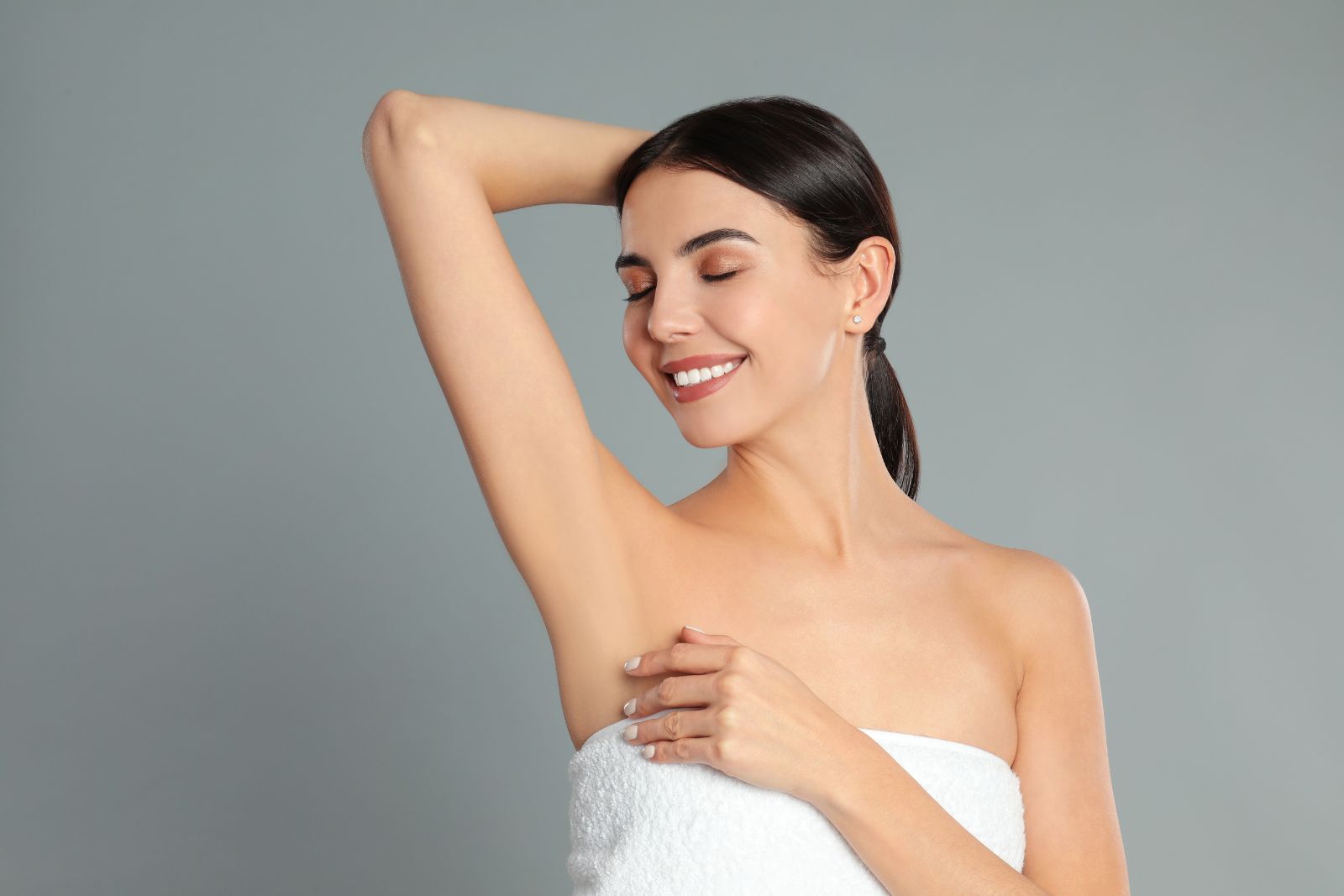 Young Woman Showing Hairless Armpit after Procedure