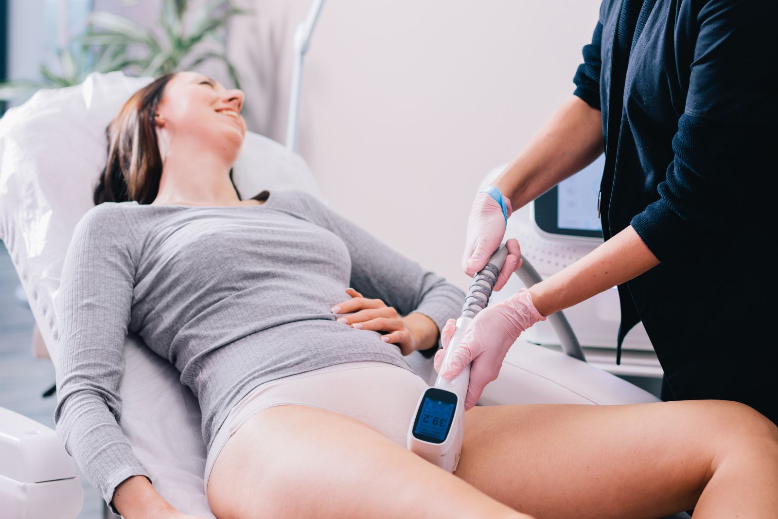 Woman getting a laser bikini area hair removal procedure by a professional beautician in a beauty salon