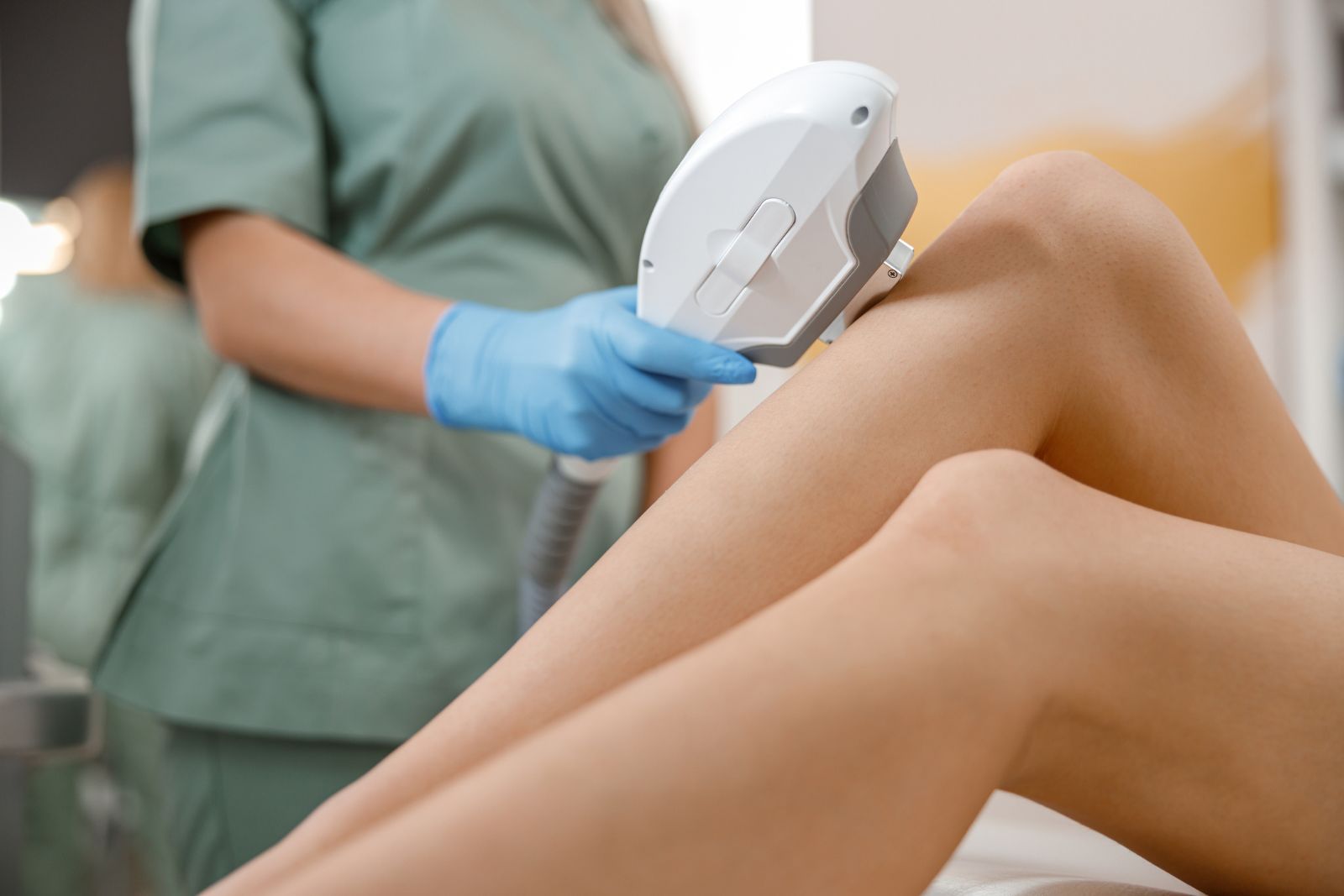 A woman's leg being treated with a laser.