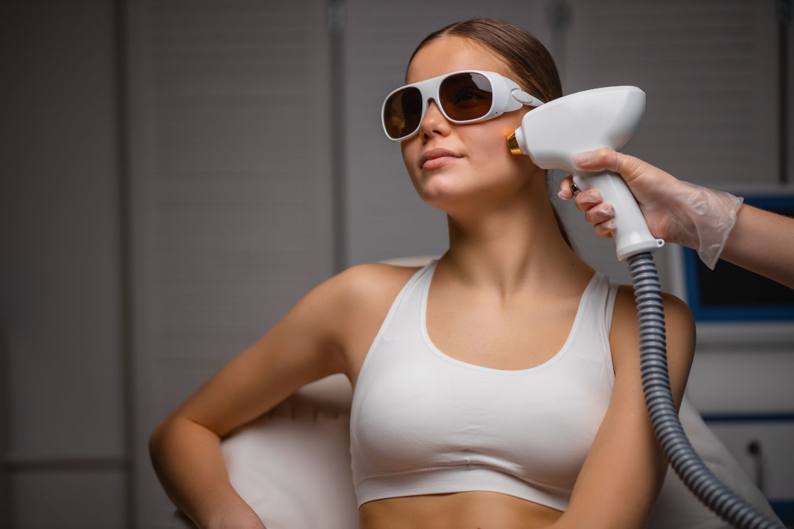 A woman is getting a laser treatment in a salon.