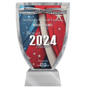 Glass award for "best of 2024 reno" in medical spa clinics, featuring a red and blue design with stars, displayed on a clear stand.