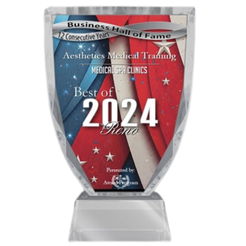 Glass award for "best of 2024 reno" in medical spa clinics, featuring a red and blue design with stars, displayed on a clear stand.