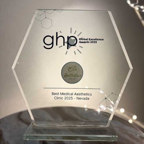 A hexagonal glass award sits on a marble surface, engraved with “ghp Global Excellence Awards 2025,” honoring “Best Med Spa & Medical Aesthetics Clinic 2025 – Reno, Nevada.”.