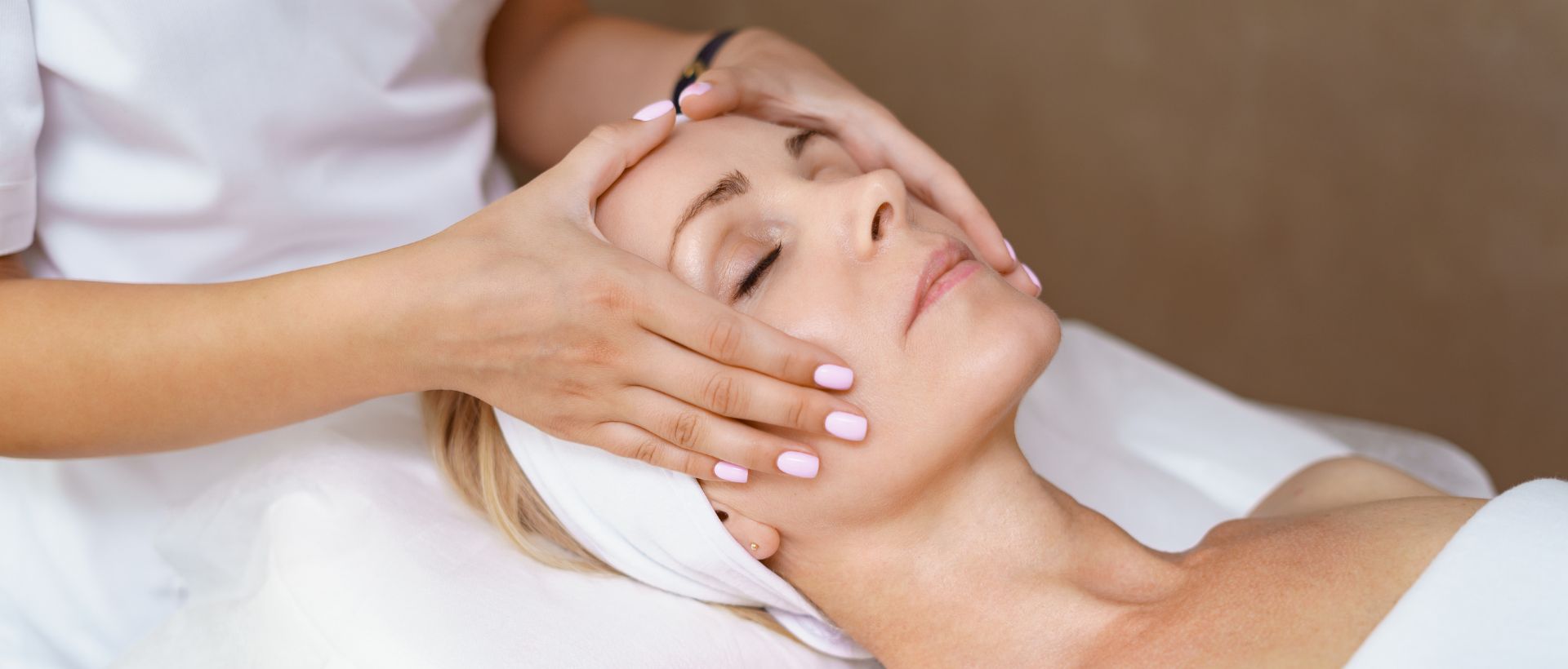 Woman enjoying a relaxing facial massage during a professional skin rejuvenation spa session.